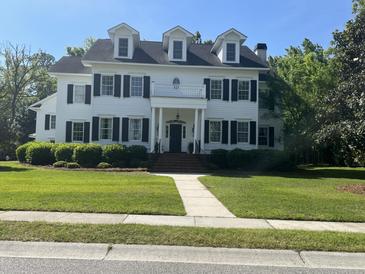 Beautiful two story home with dormer windows, black shutters and a well manicured front lawn at 3017 Ashburton Way, Mount Pleasant, SC 29466