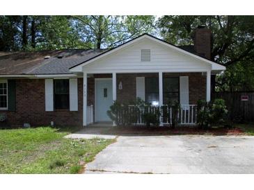 Charming one-story brick home with a cozy front porch and a well-maintained lawn at 4153 Hickory Ln, Ladson, SC 29456