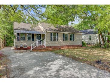 Charming single-story home with neutral siding, dark shutters, and a cozy front porch at 4709 Marlboro Pl, North Charleston, SC 29405