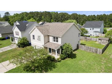 Two-story home with light siding, a blue front door, and a well-maintained lawn and landscaping at 4747 Lewis And Clark Trl, Summerville, SC 29485
