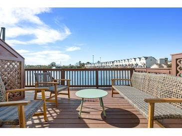 Inviting waterfront deck features stylish seating and scenic views, perfect for outdoor relaxation and entertainment at 4979 Lake Palmetto, North Charleston, SC 29418