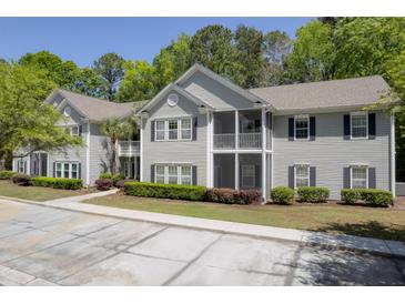 Charming two-story condo complex with gray siding, black shutters, and screened in porches at 106 Pickering Ln, Charleston, SC 29414