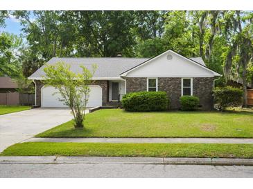 Charming brick home featuring a well-manicured lawn, mature trees, and an attached two-car garage at 119 Savannah Round, Summerville, SC 29485