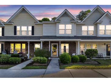 Charming townhome with well-manicured front yard landscaping and inviting covered porch at 122 Brockman Way, Goose Creek, SC 29445