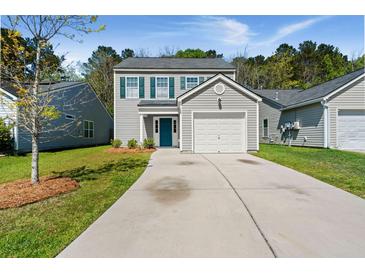 Charming two-story home with a well-manicured lawn, attached garage, and a bright blue front door at 168 Keaton Brook Dr, Summerville, SC 29485