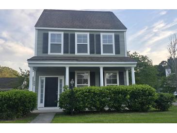 Charming two-story home with a covered front porch and well-maintained landscaping at 209 Killarney Trl, Moncks Corner, SC 29461