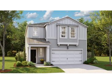 Charming two-story home featuring a well-manicured lawn and an attached two-car garage at 312 Tiliwa St, Summerville, SC 29486