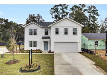 Charming two-story home with attached garage, manicured landscaping, and a welcoming front entrance at 4115 Rising Tide Dr, Summerville, SC 29485