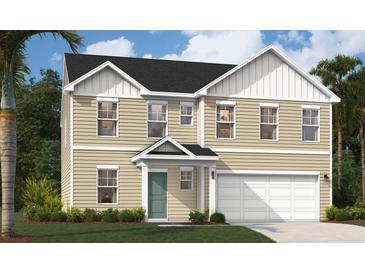Charming two-story home with a bright teal door and a two car garage at 4163 Rising Tide Dr, Summerville, SC 29485
