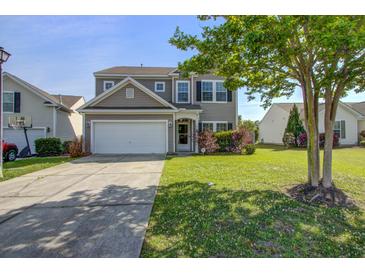 Charming two-story home with a well-maintained lawn and a two-car garage at 500 Dolphin Dr, Summerville, SC 29485