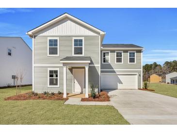 Charming two-story home with a well-manicured lawn and attached garage at 5024 Scow Ct, Summerville, SC 29485