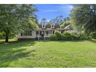 Charming single-Gathering home with a well-manicured front yard and covered front porch with dormers at 520 Givhans Rd, Ridgeville, SC 29472