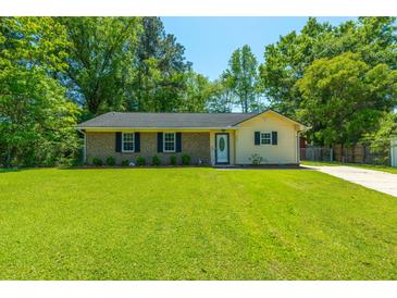 Charming one-story home with a well-manicured lawn, brick accents, and beautiful landscaping at 523 Bayshore Blvd, Goose Creek, SC 29445
