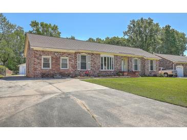 Charming brick home featuring a well-manicured lawn and long driveway, offering curb appeal at 109 Winston Way, Goose Creek, SC 29445