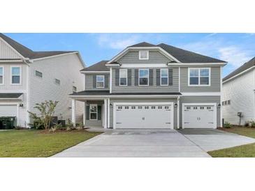Charming two-story home featuring a gray exterior, attached two-car garage, and well-maintained front lawn at 115 Seaton St, Summerville, SC 29486