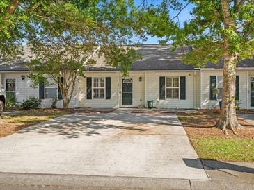 Charming single-story townhome with a well-maintained front yard and a concrete driveway at 1516 Blaze Ln, Charleston, SC 29412