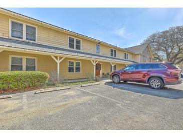 Two-story home with covered entryway, ample parking and a red SUV in the lot at 2150 Spoleto Ln # B-11, North Charleston, SC 29406