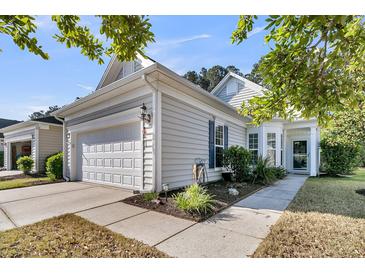 Charming home featuring a well-maintained lawn, two car garage, and attractive curb appeal at 239 Sea Lavender Ln, Summerville, SC 29486