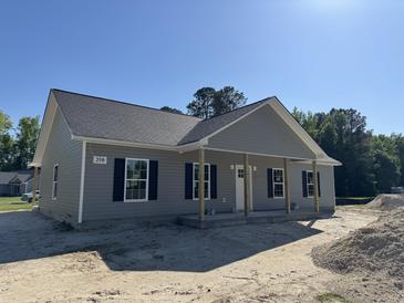 Charming single-story home featuring a covered porch and classic gray siding at 250 Dandelion Ct, Round O, SC 29474