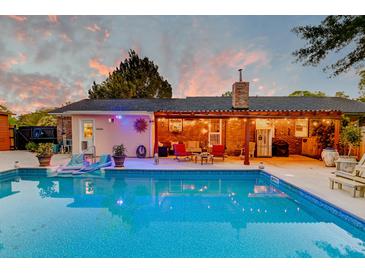Inviting backyard pool and patio with outdoor seating, perfect for entertaining under the string lights at 2506 Birkenhead Dr, Charleston, SC 29414