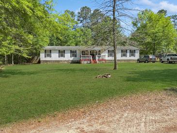 Charming single-story home with a lush green lawn and mature trees at 260 Lake Dr, Summerville, SC 29483