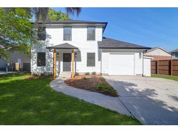 Charming two-story home with a manicured lawn, a modern door and an attached garage at 397 Parkdale Dr, Charleston, SC 29414