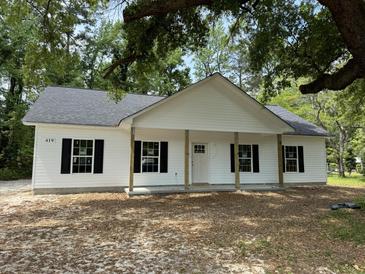 Charming single-story home featuring a covered porch and black shutters, perfect for relaxed southern living at 419 Ravenwood Rd, Walterboro, SC 29488