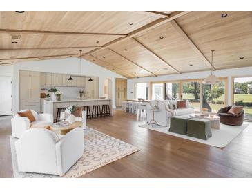 Open-concept living room featuring hardwood floors, wooden vaulted ceilings, and modern neutral-toned decor at 1183 Farm Quarter Rd, Mount Pleasant, SC 29464