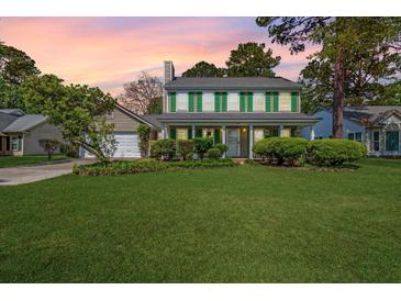 Charming two-story home with green shutters, a manicured lawn, and attached two car garage at 119 Alwyn Blvd, Summerville, SC 29485