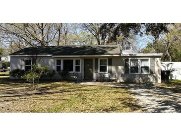 Charming single-story home featuring a cozy front porch and well-maintained landscaping at 125 Matheny Dr, Goose Creek, SC 29445