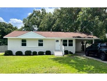 Charming single-story home boasts a well-manicured lawn and inviting curb appeal at 1487 Woodview Ln, Charleston, SC 29412