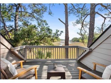 Relaxing balcony with seating area overlooking serene marsh views and lush greenery, perfect for enjoying the outdoors at 1502 Marsh Haven, Seabrook Island, SC 29455