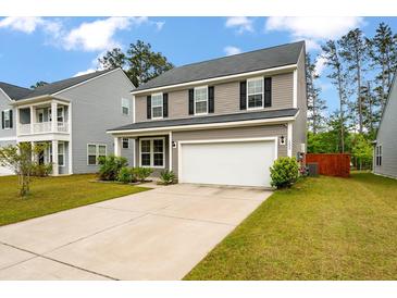 Charming two-story home with a spacious driveway and well-maintained lawn at 153 Caleb Ct, Ladson, SC 29456