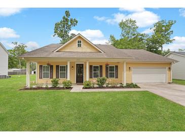 Charming yellow home with brown shutters, a well-manicured lawn, and an attached two-car garage at 1953 Suzanne St, Johns Island, SC 29455