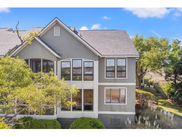 Beautiful two-story home featuring large windows offering ample natural light and views of the surrounding landscape at 2105 Landfall Way, Seabrook Island, SC 29455