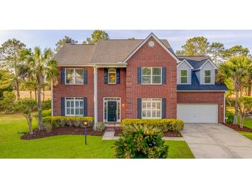 Stunning brick home featuring lush landscaping, attached garage and welcoming entrance at 2524 Deer Walk Way, Mount Pleasant, SC 29466
