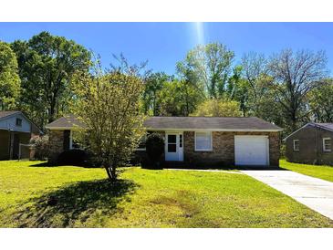 Charming brick home featuring a well-maintained lawn and an attached one car garage at 3215 Bonanza Rd, Charleston, SC 29414