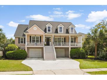 Charming two-story home features a double front porch, manicured lawn, and driveway at 3526 Stockton Dr, Mount Pleasant, SC 29466