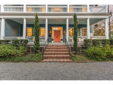Charming two-story home with a covered porch, landscaped yard, and inviting front door at 66 Warren St # Main House Only, Charleston, SC 29403