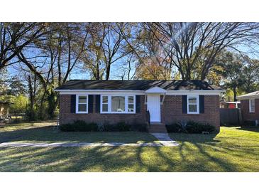 Charming brick single-story home with manicured lawn and mature trees at 8 Eucalyptus Ave, North Charleston, SC 29418