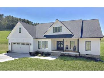 Charming one story home with a well maintained lawn, rocking chair front porch and attached two car garage at 00 Woodland Dr, Summerville, SC 29485