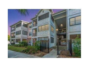 Inviting condo building featuring multi-level balconies and manicured landscaping at 1025 Riverland Woods Pl # 1108, Charleston, SC 29412