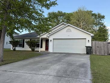 Charming single-story home featuring a two-car garage, red front door, and a well-maintained front yard at 1341 Belle Grove Cir, Hanahan, SC 29410