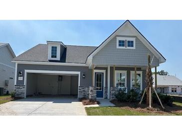 Charming single-Gathering home with a craftsman-style design, attached garage, and beautifully landscaped front yard at 135 Summerwind Dr, Summerville, SC 29486