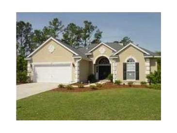 Charming single-story home with a well-manicured lawn, two-car garage, and beautiful landscaping at 1409 Endicot Way, Mount Pleasant, SC 29466