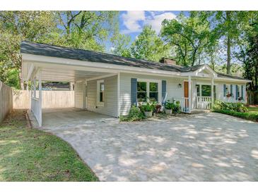 Charming single-story home featuring a covered carport, light gray siding and manicured landscaping at 238 Howle Ave, Charleston, SC 29412
