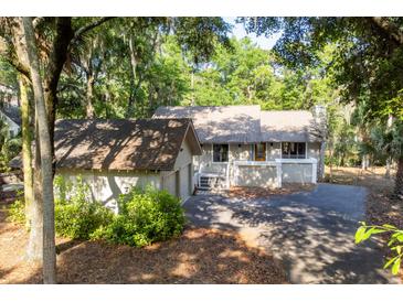 Charming single-story home featuring mature trees, a private driveway and a spacious, attached two-car garage at 2766 Old Oak Walk, Seabrook Island, SC 29455