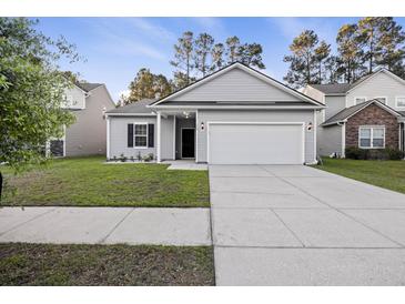 Charming single-story home with gray siding, well-manicured lawn, and an attached two-car garage at 278 Decatur Dr, Summerville, SC 29483