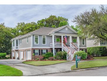 Inviting home featuring a charming porch with columns, a double staircase, and professional landscaping at 3567 Somerset Hills Ct, Mount Pleasant, SC 29466