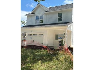 Two-story home with white siding, a front-facing garage, and a covered front porch at 4124 O'Hear Ave, North Charleston, SC 29405